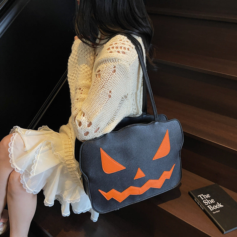 Halloweenová taška cez rameno s dizajnom tekvice v čiernej a oranžovej farbe – Norevia