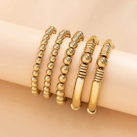 Belmira armbåndssæt – Sæt med 5 elastiske kuglearmbånd i guld- og sølvfarve